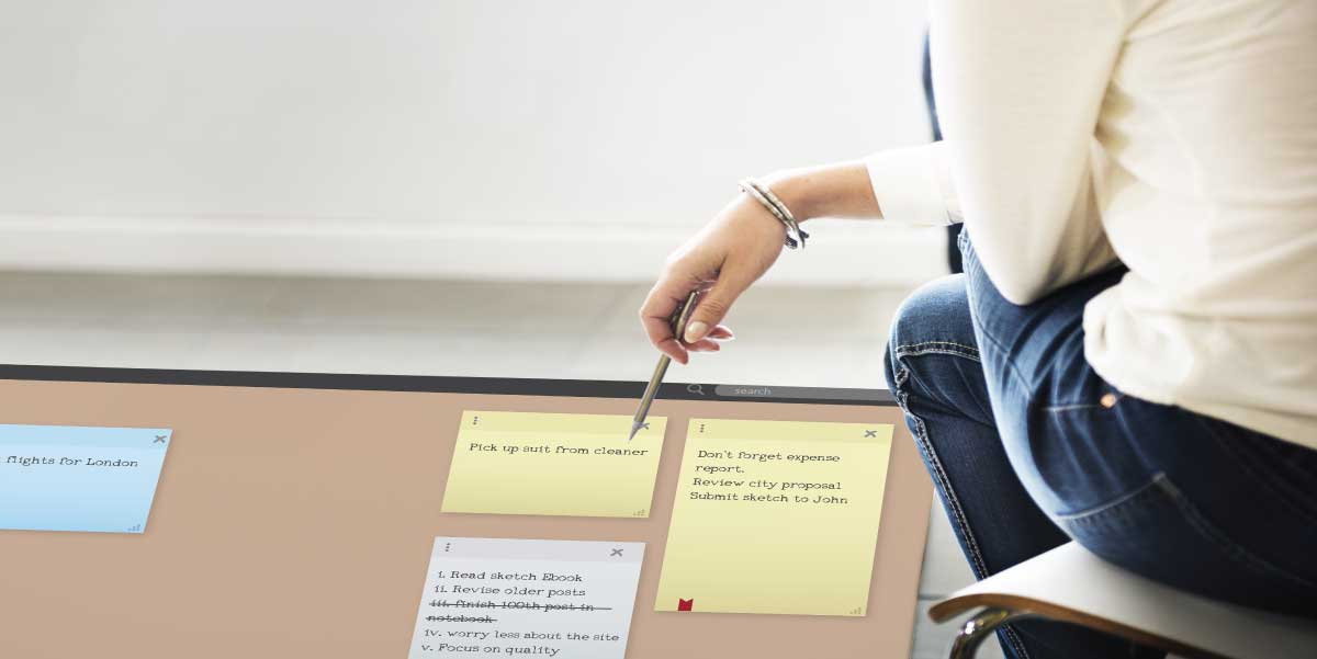 Writing decisions on post it notes on a cork board