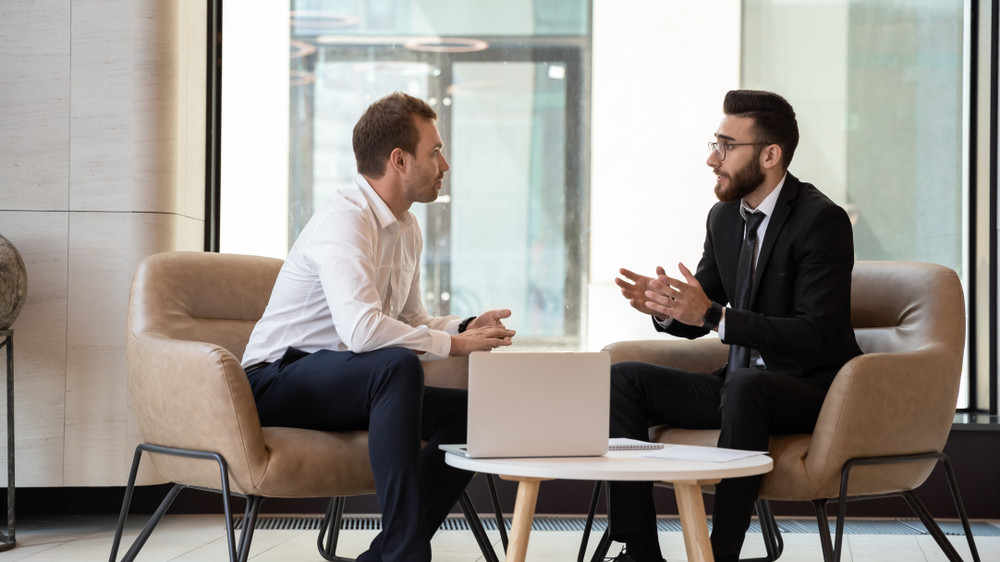 manager and employee discussing about the benefits of their outsourcing partnership