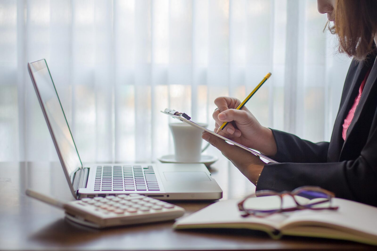 female financial controller checking items off list