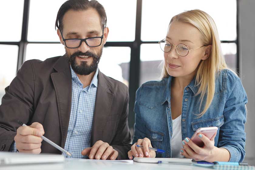 two business professionals comparing accounting providers