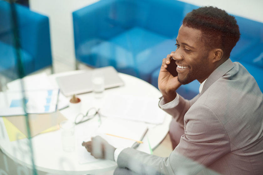 Young black accountant talking on a phone