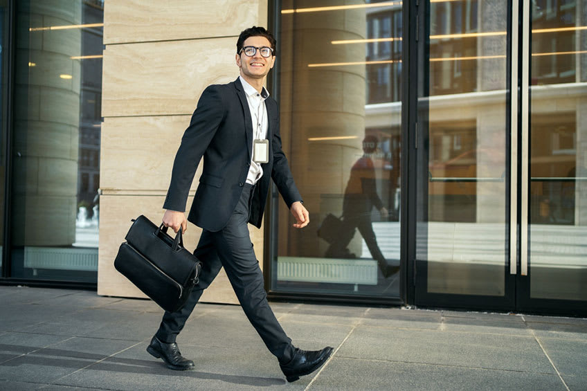  Transitioning director walking into building for the first day of his new CFO position