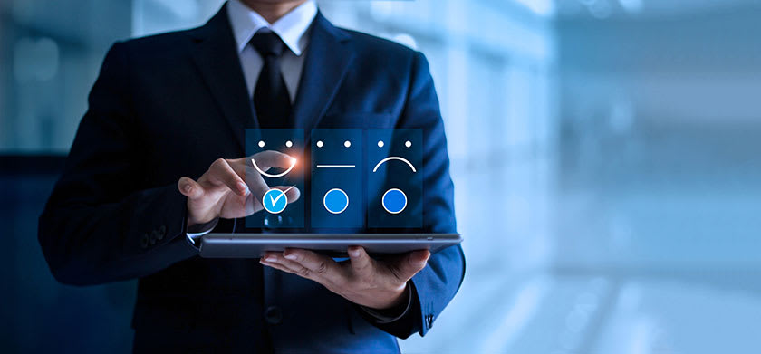 CFO holding tablet with customer experience graphic overlay background