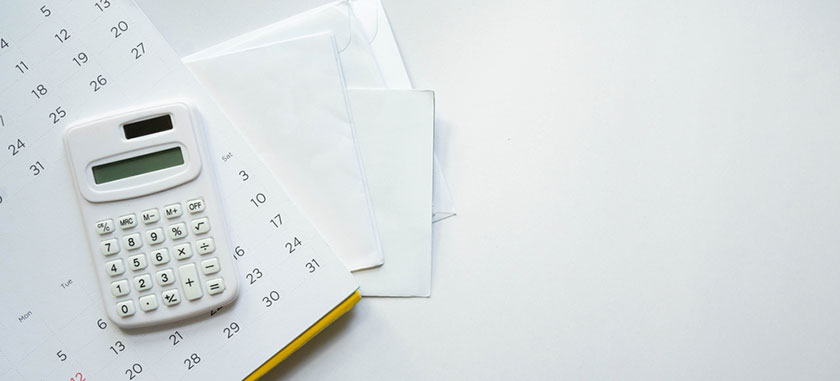calculator on table on top of papers with on-demand pay calculations of an employee
