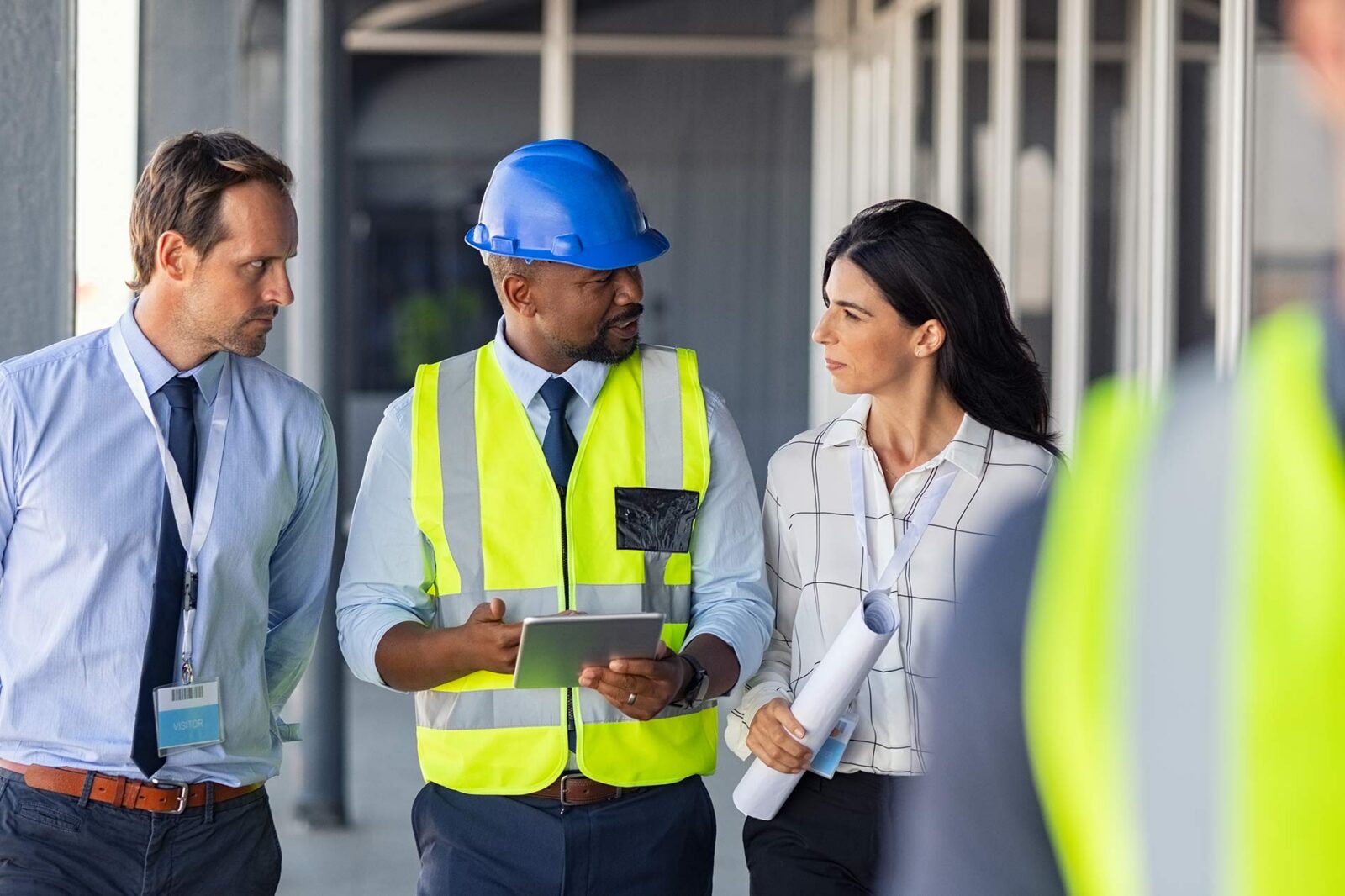 CFO from construction company talking to project manager and supervisor on field