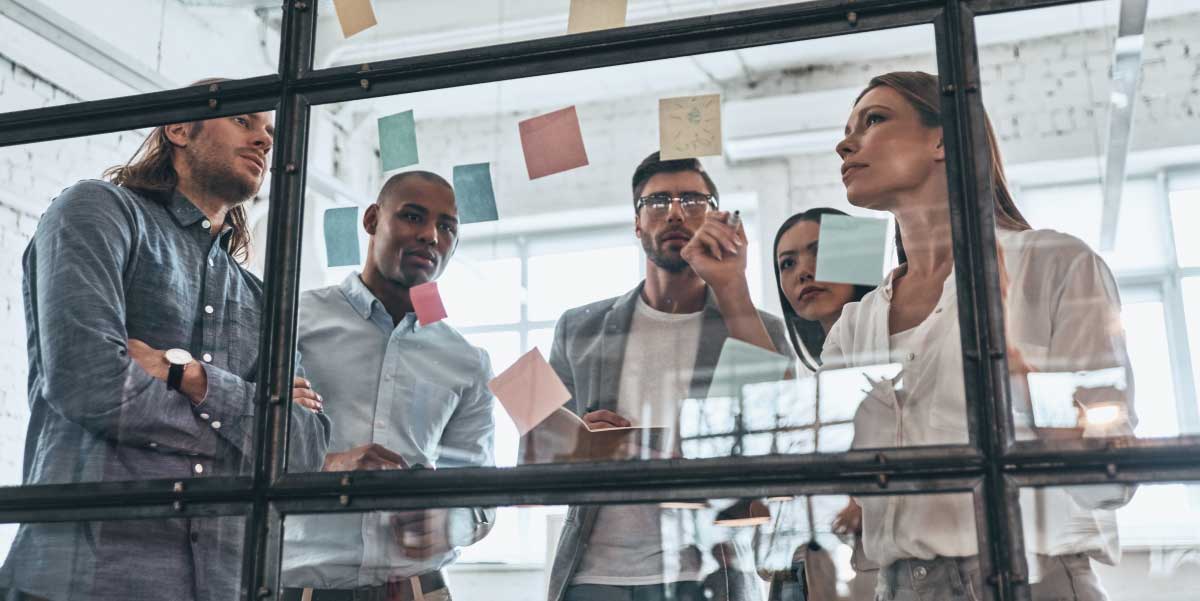 Group of people brainstorming about the keys to successful outsourcing