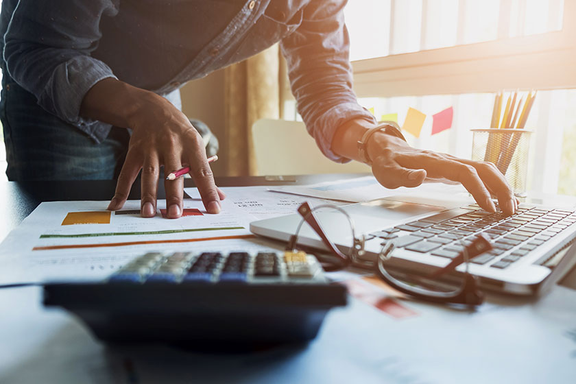 accountant looking at reports and his outsourcing accounting step by step guide