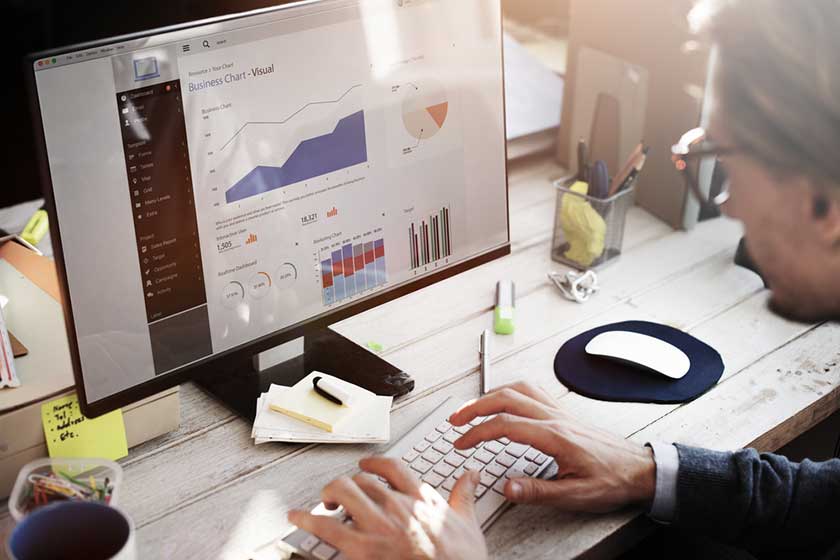 CFO setting up new AI tools on his computer trying to keep up with new accounting trends