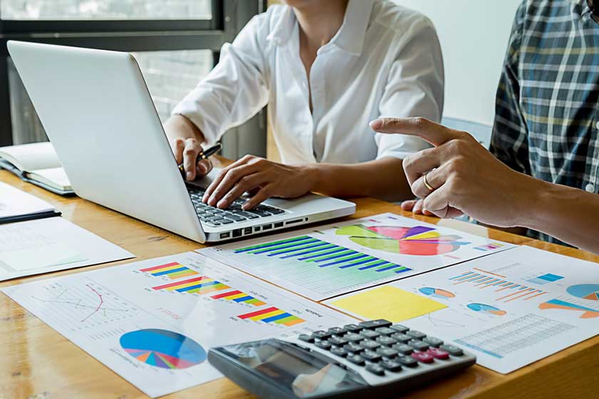 accountants working on budget plan including how much they'll charge for their service