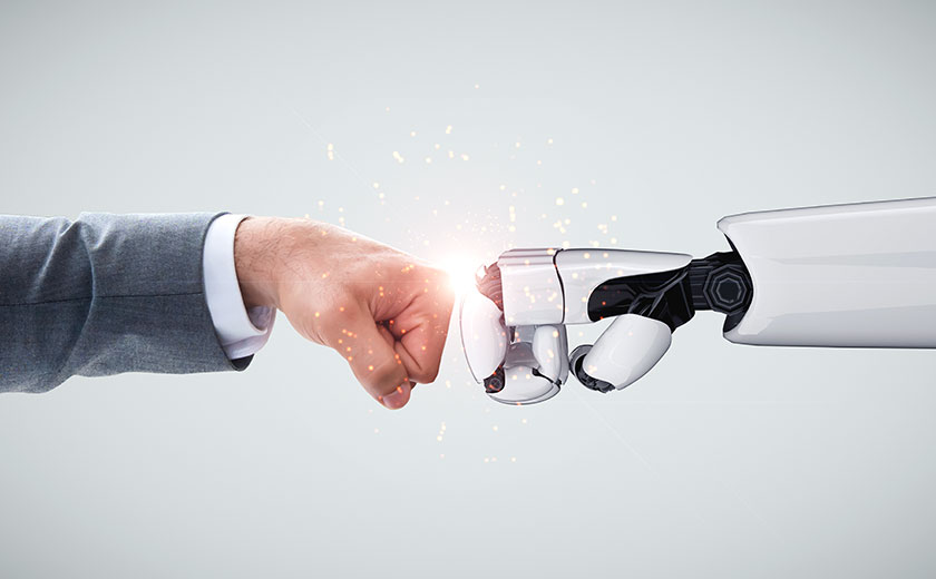Robot and human arms bumping fists signifying the use of RPA in modern businesses