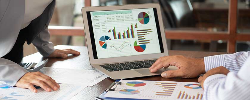 Controller setting up computer dashboard with the most important KPIs