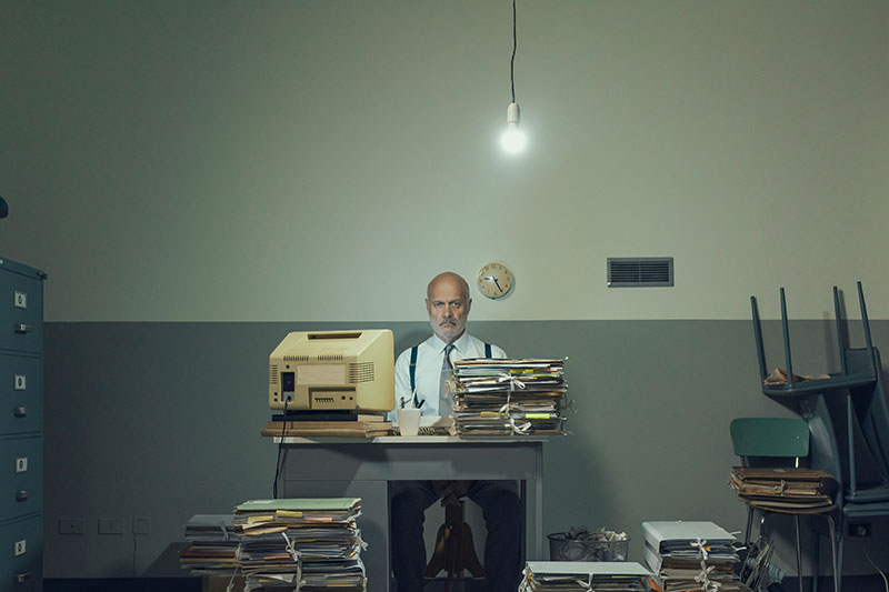 burnt out accountant downloading outsourcing assessment on his computer