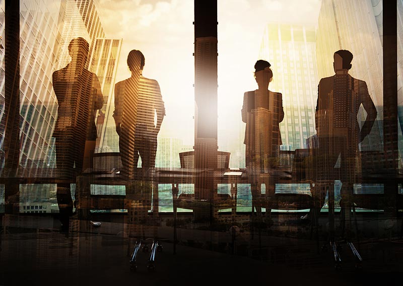 accounting team looking out a building's window