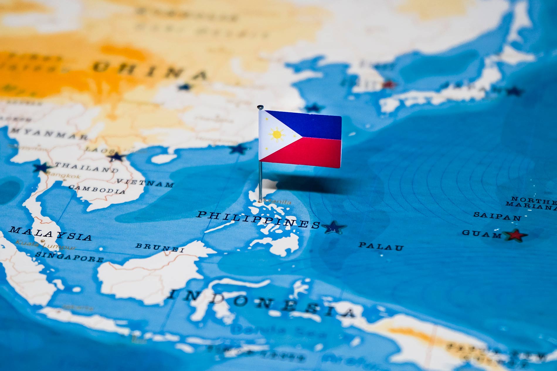 world map in an offshoring company showing Filipino flag pinned to Manila
