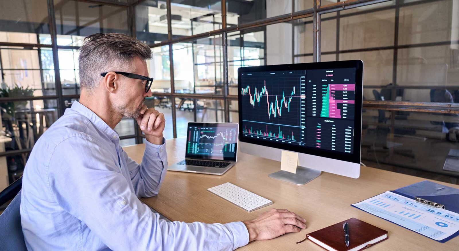 financial risk management specialist analyzing data analytics on computer screen