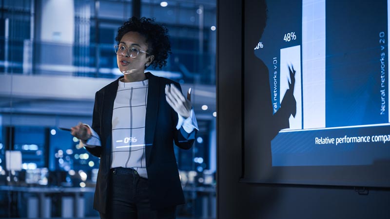 businesswoman giving a presentation on the impact of AI in the finance industry
