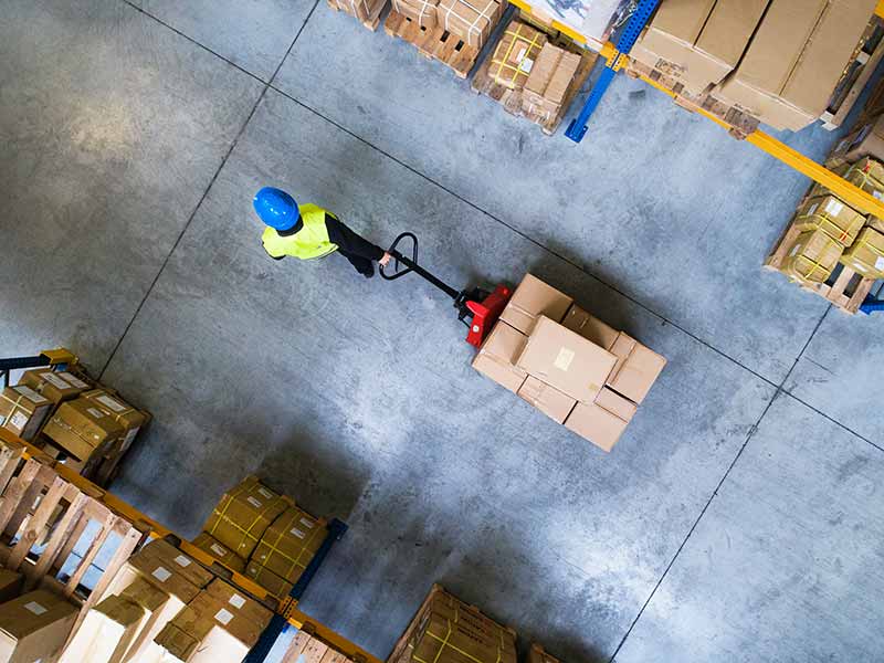 warehouse worker working through the future of procurement