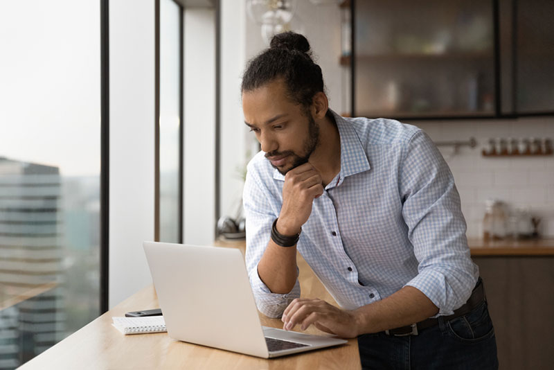 business owner asking questions to outsourcing company on computer